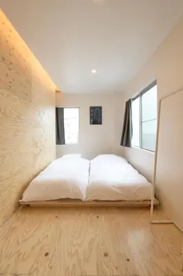 a bedroom with a bed with a mirror at SHORTsuido in Tokyo