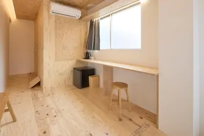 a small room with a stool and a window at SHORTsuido in Tokyo