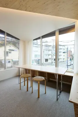an office with a large table and two chairs and windows at SHORTsuido in Tokyo