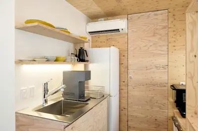 a small kitchen with a sink and a refrigerator at SHORTsuido in Tokyo