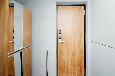 a wooden door in a room with at Shinjuku NY House 301 in Tokyo