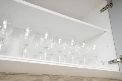 a bunch of wine glasses hanging on a wall at Shinjuku NY House 301 in Tokyo