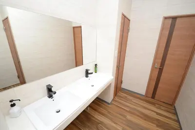 a bathroom with two sinks and a large mirror at Shinjuku NY House 301 in Tokyo