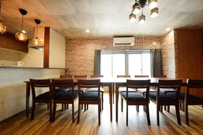 a dining room with a large table and chairs at Shinjuku NY House 301 in Tokyo