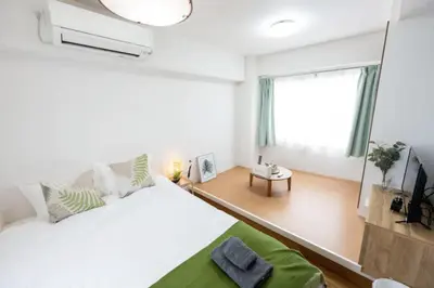a white bedroom with a large bed and a window at \u4eca\u548cHotel in Tokyo