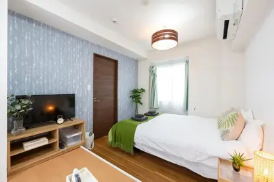 a bedroom with a large bed and a tv at \u4eca\u548cHotel in Tokyo