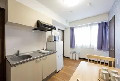 a small kitchen with a sink and a table at \u4eca\u548cHotel in Tokyo