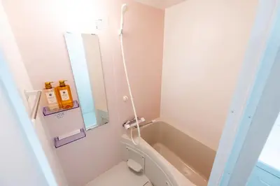 a bathroom with a tub and a toilet and a sink at \u4eca\u548cHotel in Tokyo