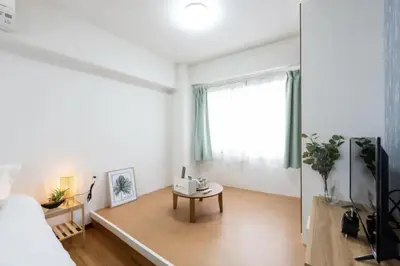 a living room with a bed and a table at \u4eca\u548cHotel in Tokyo