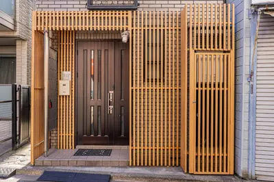 an entrance to a building with a wooden door at Family House \u857e \u6c60\u888b\u5f92\u6b65\u5708\u5168\u65b0\u88c5\u4fee\u65e5\u5f0f\u6237\u5efa\u6c11\u5bbf in Tokyo