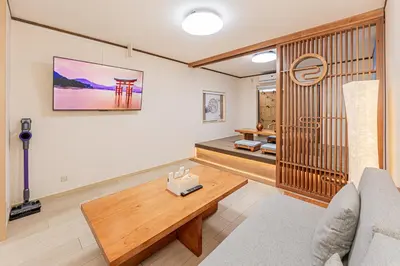 a living room with a couch and a table at Family House \u857e \u6c60\u888b\u5f92\u6b65\u5708\u5168\u65b0\u88c5\u4fee\u65e5\u5f0f\u6237\u5efa\u6c11\u5bbf in Tokyo
