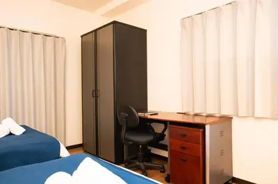 a bedroom with a desk and a cabinet and a bed at \u6cca\u9732Hakuro 3\u968e in Tokyo