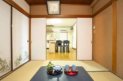 a living room with a table with dishes on it at \u6cca\u9732Hakuro 3\u968e in Tokyo