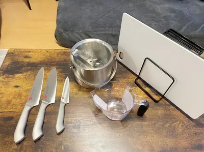 a table topped with knives and a laptop computer at Comptoir Shinjuku 411 - Vacation STAY 17791 in Tokyo
