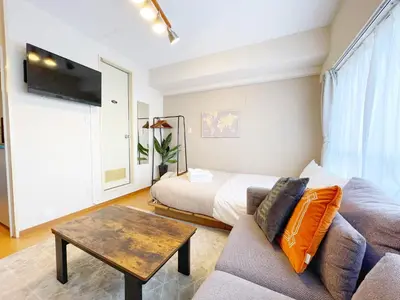 a living room with a couch and a bed at Comptoir Shinjuku 411 - Vacation STAY 17791 in Tokyo
