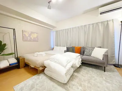 a living room with a bed and a couch at Comptoir Shinjuku 411 - Vacation STAY 17791 in Tokyo