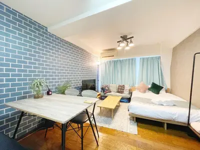 a living room with a table and a couch at Fujiwa Excel Dogenzaka 602 - Vacation STAY 17792 in Tokyo