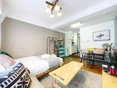 a room with two beds and a table and a dining room at Fujiwa Excel Dogenzaka 602 - Vacation STAY 17792 in Tokyo