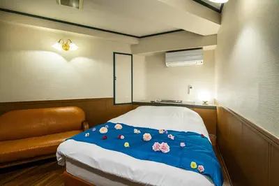 a room with a bed with flowers on it at Hotel SUNROAD Adult Only in Tokyo