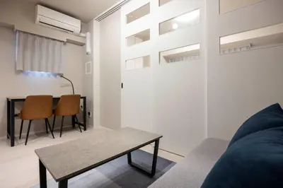 a living room with a couch and a table at MAT Ryogoku in Tokyo
