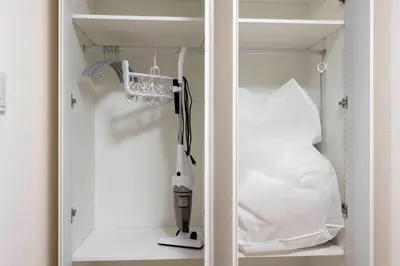 a closet with a white appliance on a shelf at MAT Ryogoku in Tokyo