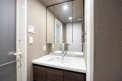 a bathroom with a sink and a large mirror at MAT Ryogoku in Tokyo