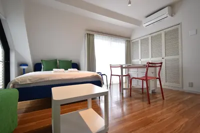 a bedroom with a bed and a table and chairs at Solana Roppongi in Tokyo