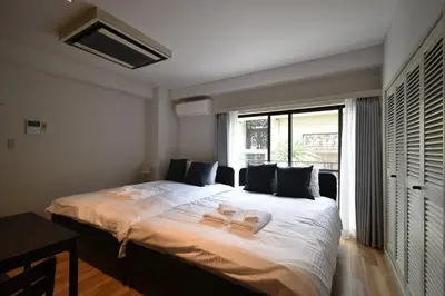 a bedroom with a large bed with two slippers on it at Solana Roppongi in Tokyo