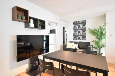 a dining room and living room with a table and chairs at Solana Roppongi in Tokyo