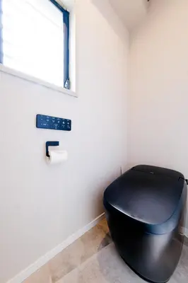 a black toilet in a room with a window at Solana Roppongi in Tokyo