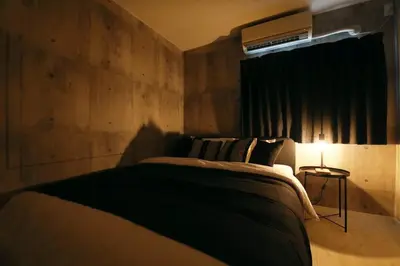 a bedroom with a bed with a black blanket at AirHOME TOKYO EBISU101 in Tokyo