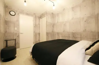 a bedroom with a bed and a clock on the wall at AirHOME TOKYO EBISU101 in Tokyo