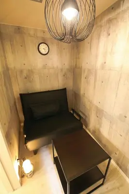 a room with a couch and a clock on a wall at AirHOME TOKYO EBISU101 in Tokyo