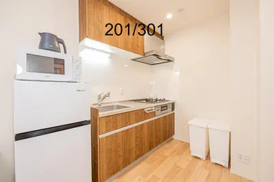 a kitchen with a white refrigerator and a sink at Newly build Family-APT , Shinjuku Shibuya Ueno in 15 minutes by train in Tokyo