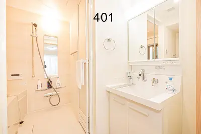 a white bathroom with a sink and a shower at Newly build Family-APT , Shinjuku Shibuya Ueno in 15 minutes by train in Tokyo