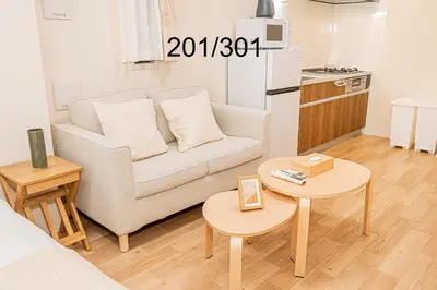 a living room with a couch and a table at Newly build Family-APT , Shinjuku Shibuya Ueno in 15 minutes by train in Tokyo