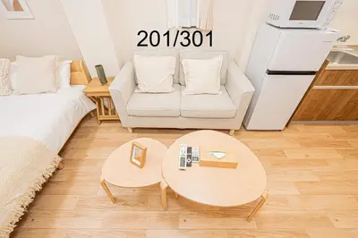a living room with a couch and a table at Newly build Family-APT , Shinjuku Shibuya Ueno in 15 minutes by train in Tokyo