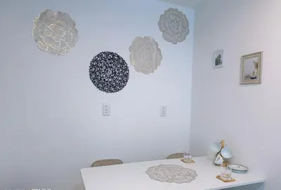 a dining room table with a white wall with decorations on it at \u6771\u4eac\u30b9\u30ab\u30a4\u30c4\u30ea\u30fc\u30cf\u30a6\u30b9JoY in Tokyo