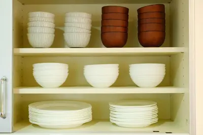 a shelf filled with white bowls and plates at Beyond Comfort \u65b0\u5bbf\u5927\u4e45\u4fdd - \u6700\u592710\u540d\u3067\u3086\u3063\u305f\u308a\u6ede\u5728 in Tokyo