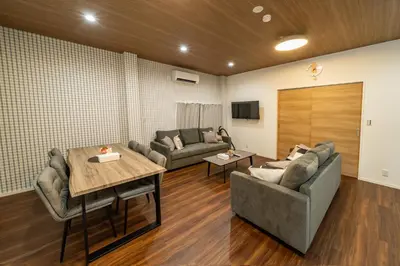 a living room with a couch and a table at 98, Higashi-tateishi A 1st floor of the apartment, \u6771\u7acb\u77f3A 1F in Tokyo