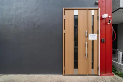 a wooden door with a sign on it next to a building at 98, Higashi-tateishi A 1st floor of the apartment, \u6771\u7acb\u77f3A 1F in Tokyo