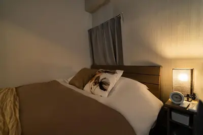 a bedroom with a bed with a pillow on it at 98, Higashi-tateishi A 1st floor of the apartment, \u6771\u7acb\u77f3A 1F in Tokyo