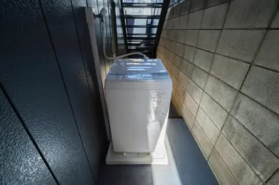 a trash can sitting in a hallway in a building at 98, Higashi-tateishi A 1st floor of the apartment, \u6771\u7acb\u77f3A 1F in Tokyo