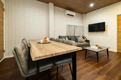 a dining room with a table and a couch at 98, Higashi-tateishi A 1st floor of the apartment, \u6771\u7acb\u77f3A 1F in Tokyo