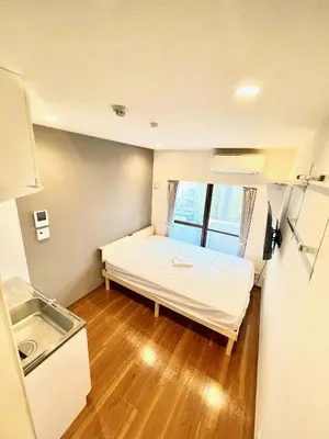 a small room with a bed and a sink at NEW fukuhana\u6771\u65b0\u5bbf in Tokyo