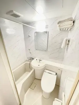 a white bathroom with a toilet and a tub at NEW fukuhana\u6771\u65b0\u5bbf in Tokyo