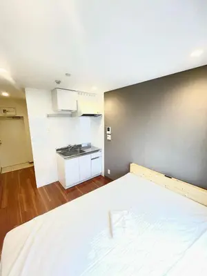 an empty room with a bed and a kitchen at NEW fukuhana\u6771\u65b0\u5bbf in Tokyo
