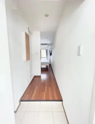 a hallway of a house with white walls and wooden floors at NEW fukuhana\u6771\u65b0\u5bbf in Tokyo