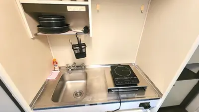 a small kitchen with a sink and a stove at HUJI Shinjuku House in Tokyo