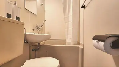 a small bathroom with a toilet and a sink at HUJI Shinjuku House in Tokyo